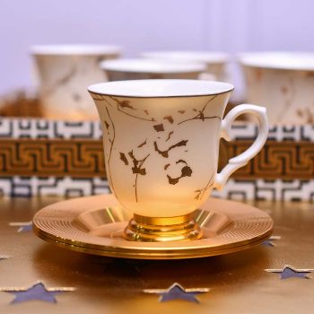 White coffee cup and saucer with gold line pattern