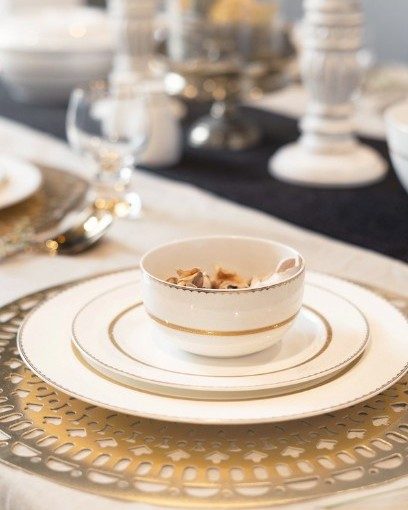 A Crocurry table setting: gold-rimmed bone china on a gilded charger